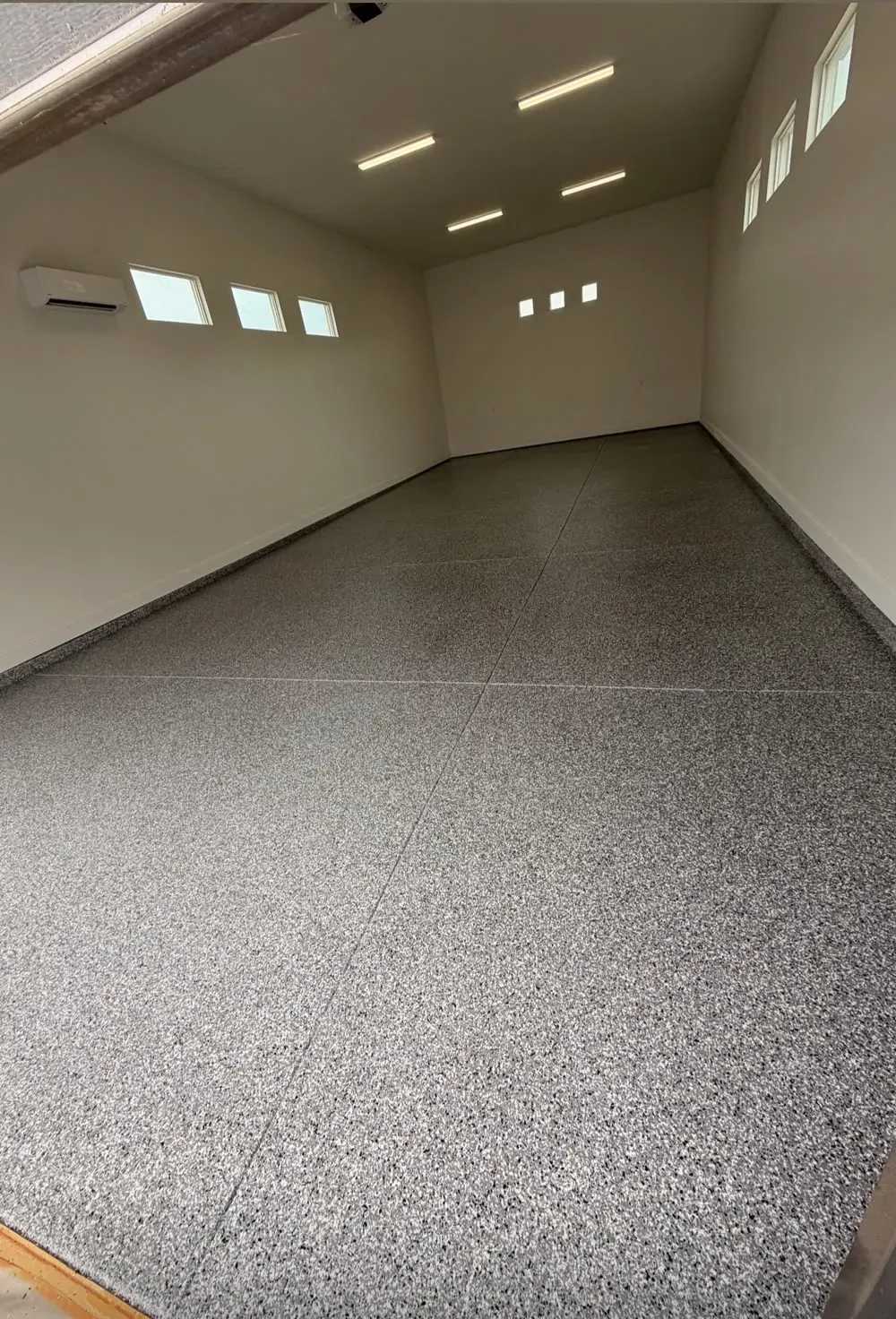 Garage floor in the Cape Cod flake blend, seen down the length of a long garage