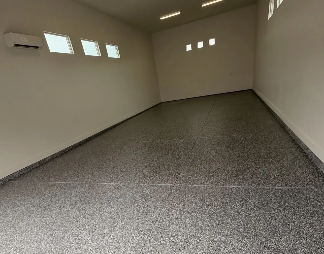 Garage floor in the Cape Cod flake blend, seen across the width of the garage