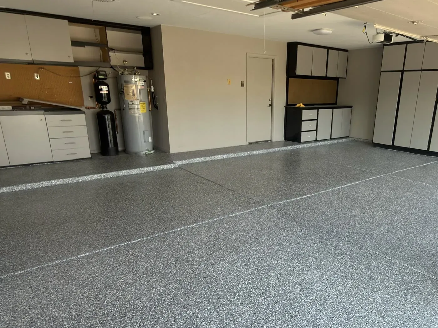 Garage floor in the Olympic flake blend, running past a wall of storage cabinets